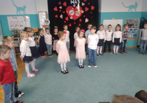 Helena, Aniela i Jaś stoją na środku sali, recytują wiersze dla Babci i Dziadka