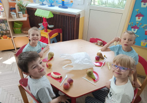 Dzieci ze stolika czerwonego kroją owoce