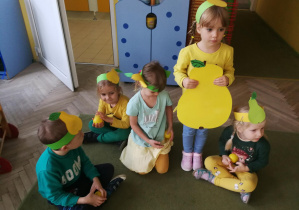 Misia, Remik, Kubuś i Hania, trzymający żółte piłeczki-gruszki, usiedli przy Gruszy - Lenie
