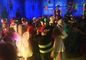 Dzieci uczestniczą w zabawach tanecznych na balu karnawałowym