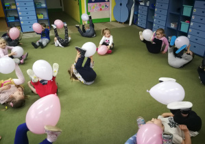 Dzieci trzymają balony stopami