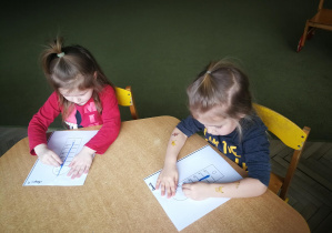 Marysia i Remik rysują kredkami pastelowymi linie pionowe w rytmie piosenki "Termometr"