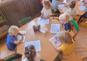 Dzieci kolorują przy stoliku