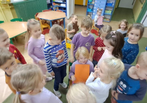 Dzieci ustawiły się przy koleżance z kartką w kolorze pomarańczowym