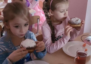 Oliwia i Nina podczas jedzenia pączka
