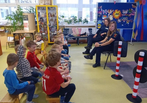 Panie ze Straży Miejskiej rozmawiają z przedszkolakami