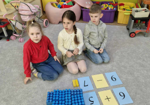 starszaki rozwiązują równania matematyczne na dywanie