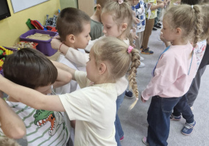Dziewczynki zakładają krawaty swoim kolegom