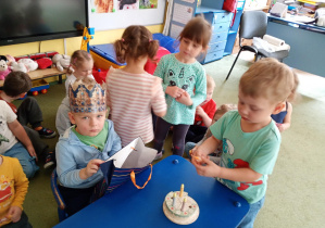 Chłopiec częstuje się urodzinowym cukierkiem od kolegi