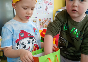 Chłopiec częstuje się urodzinowym cukierkiem od kolegi